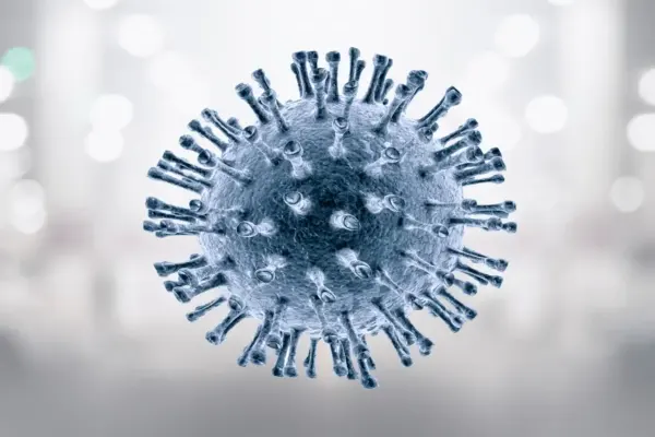 Nahaufnahme eines kugelförmigen Virus mit stachelartigen Auswüchsen vor unscharfem Hintergrund.
