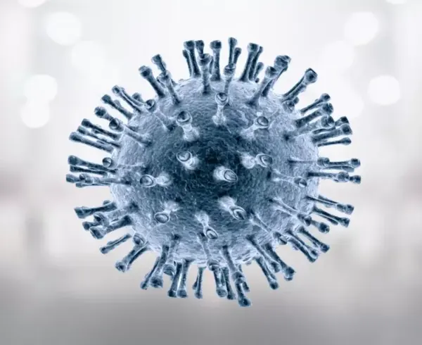 Nahaufnahme eines kugelförmigen Virus mit stachelartigen Auswüchsen vor unscharfem Hintergrund.